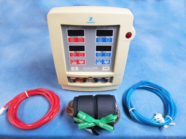 A medical device with a red, blue, and green cord.