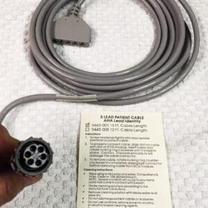 A person is holding a grey cable with a label on it.