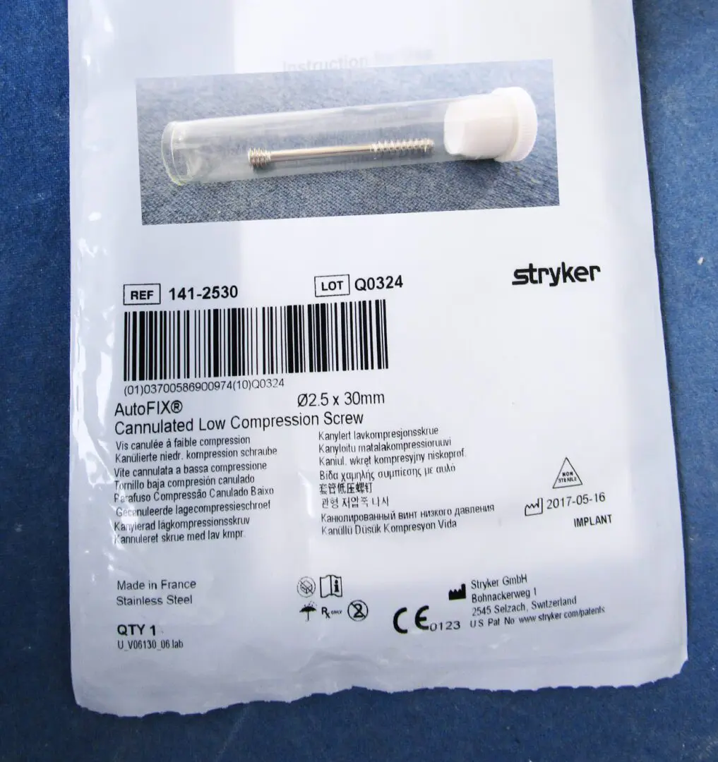 A package of medical supplies with a needle and cotton swab.