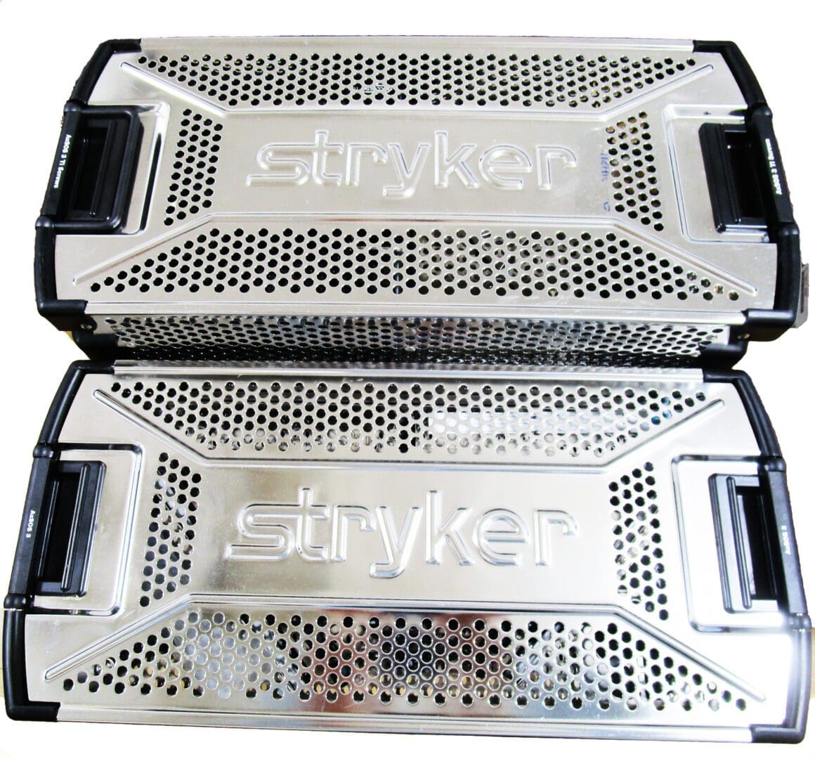 A pair of silver metal trays with black handles.