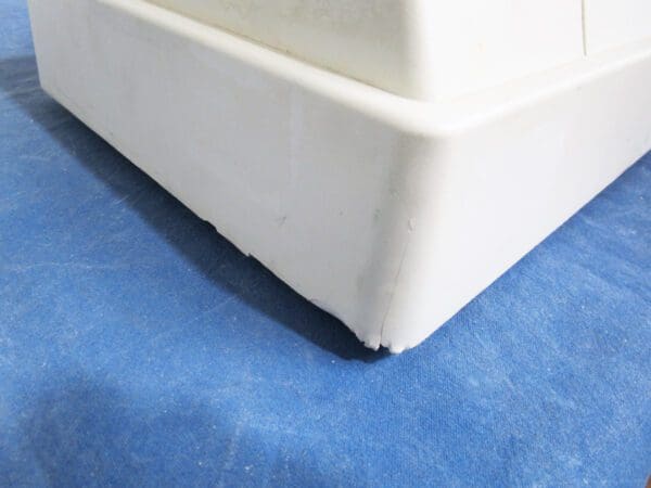 A close up of the corner of a white sink.