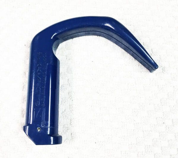 A blue plastic handle on a white surface.