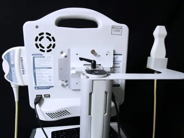 A white machine with a device attached to it.