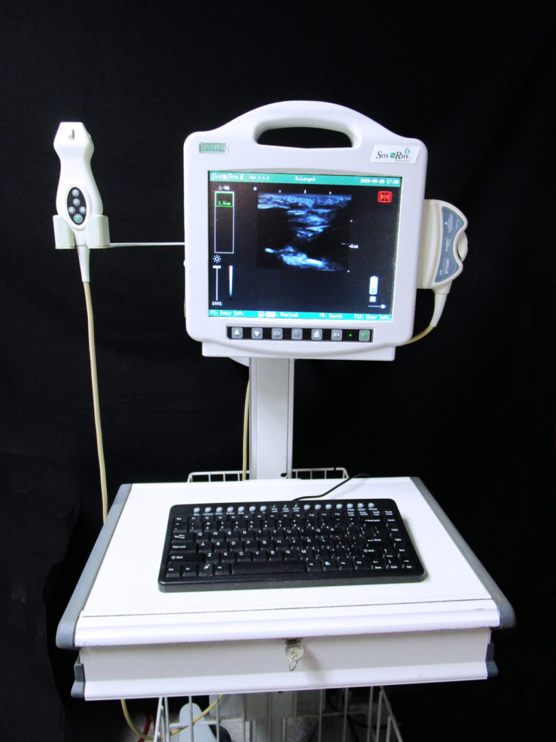 An ultrasound machine with a keyboard and monitor.