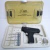 A gun is in the box with some tools inside.