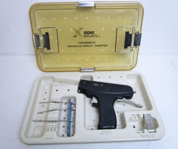 A gun is in the box with some tools inside.