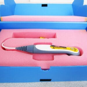 A pink box with a yellow and white electric hair iron in it.