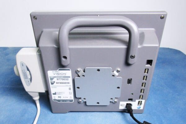 A computer monitor with the back of it hooked up to a wall.