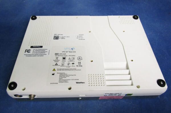 A white computer with many buttons and wires.