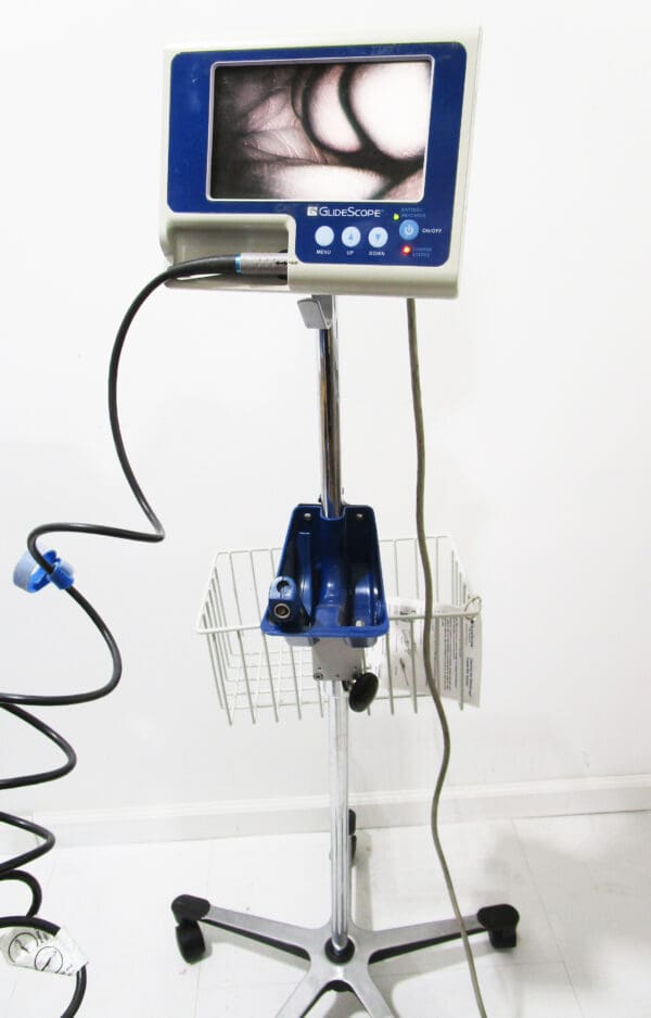 A blue and white scale with wires attached to it