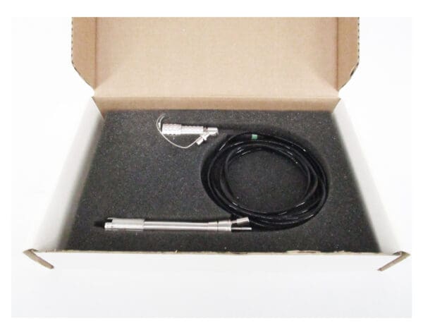 Silver probe and black cable in box.