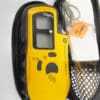 Yellow pulse oximeter in a black case.
