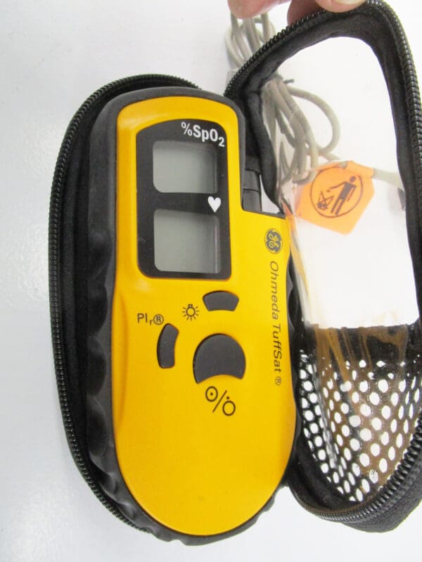 Yellow pulse oximeter in a black case.