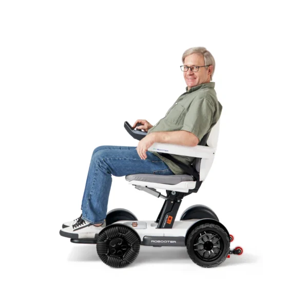 Man smiling while riding a Robooter.