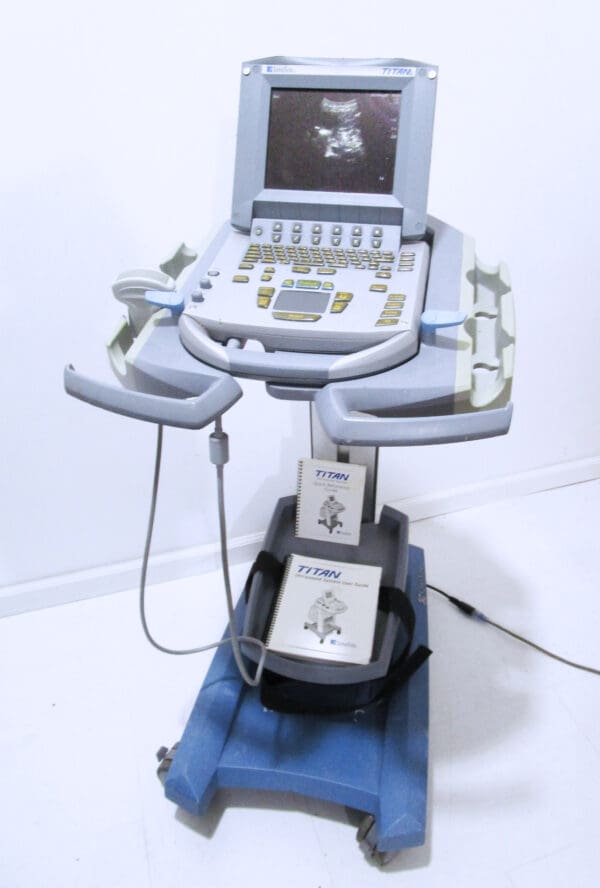 Ultrasound machine with manuals on a cart.