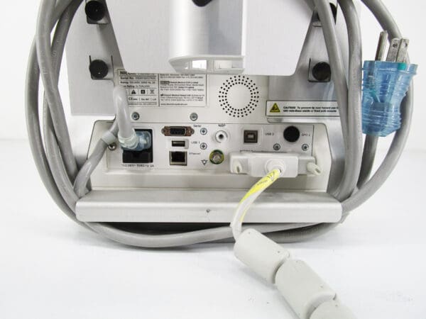 A computer monitor with wires plugged in.